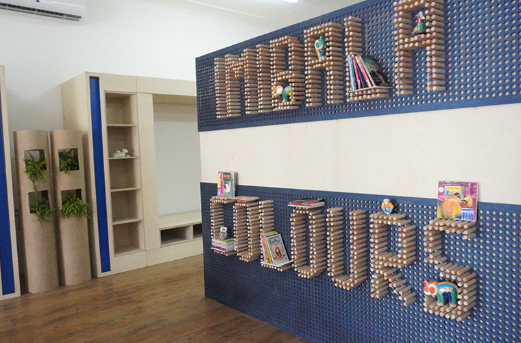 Repurposed stands, into a library and play area